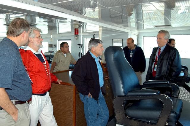 NASA image: KENNEDY SPACE CENTER, FLA. -- NASA Deputy Associate Administrator for Space Station and Shuttle Programs Michael Kostelnik (center) is given a tour of a solid rocket booster (SRB) retrieval ship by United Space Alliance (USA) employee Joe Chaput (right).  NASA and USA Space Shuttle program management are participating in a leadership workday.  The day is intended to provide management with an in-depth, hands-on look at Shuttle processing activities at KSC.