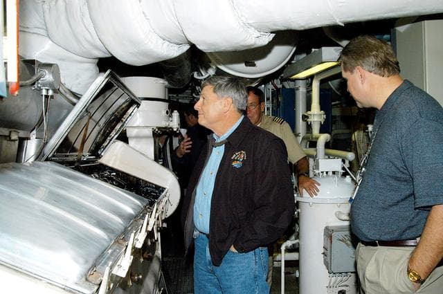 NASA image: KENNEDY SPACE CENTER, FLA. -- NASA Deputy Associate Administrator for Space Station and Shuttle Programs Michael Kostelnik (left) tours a solid rocket booster (SRB) retrieval ship at Cape Canaveral.  NASA and United Space Alliance (USA) Space Shuttle program management are participating in a leadership workday.  The day is intended to provide management with an in-depth, hands-on look at Shuttle processing activities at KSC.