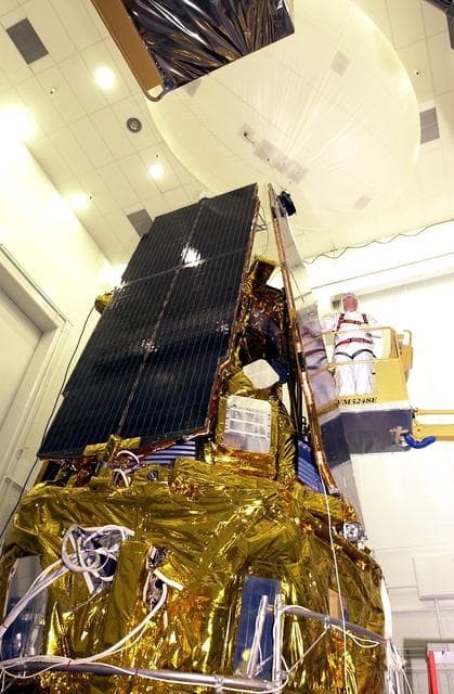 NASA image: VANDENBERG AFB, CALIF. -  In the NASA spacecraft processing facility on North Vandenberg Air Force Base, a worker checks the installation of a solar array panel onto the Gravity Probe B spacecraft.  Installing each array is a 3-day process and includes a functional deployment test.  The Gravity Probe B mission is a relativity experiment developed by NASA’s Marshall Space Flight Center, Stanford University and Lockheed Martin.  The spacecraft will test two extraordinary predictions of Albert Einstein’s general theory of relativity that he advanced in 1916: the geodetic effect (how space and time are warped by the presence of the Earth) and frame dragging (how Earth’s rotation drags space and time around with it).  Gravity Probe B consists of four sophisticated gyroscopes that will provide an almost perfect space-time reference system.  The mission will look in a precision manner for tiny changes in the direction of spin.