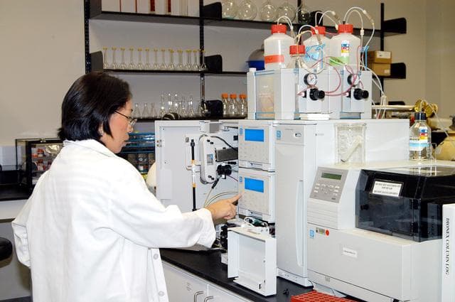 NASA image: KENNEDY SPACE CENTER, FLA. -- Lanfang Levine, with Dynamac Corp., helps install a Dionex DX-500 IC/HPLC system  in the Space Life Sciences Lab.  The equipment will enable analysis of volatile compounds, such as from plants. The 100,000 square-foot facility houses labs for NASA’s ongoing research efforts, microbiology/microbial ecology studies and analytical chemistry labs. Also calling the new lab home are facilities for space flight-experiment and flight-hardware development, new plant growth chambers, and an Orbiter Environment Simulator that will be used to conduct ground control experiments in simulated flight conditions for space flight experiments.  The SLS Lab, formerly known as the Space Experiment Research and Processing Laboratory or SERPL, provides space for NASA’s Life Sciences Services contractor Dynamac Corporation, Bionetics Corporation, and researchers from the University of Florida. NASA’s Office of Biological and Physical Research will use the facility for processing life sciences experiments that will be conducted on the International Space Station. The SLS Lab is the magnet facility for the International Space Research Park at KSC being developed in partnership with Florida Space Authority.