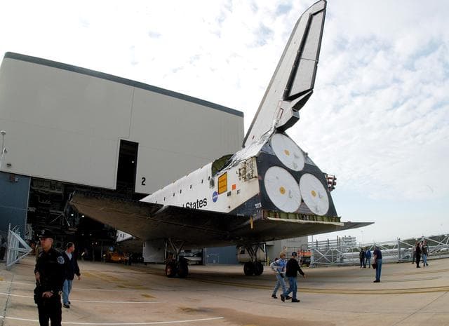 NASA image: KENNEDY SPACE CENTER, FLA. -- Endeavour backs out of the Orbiter Processing Facility for temporary transfer to the Vehicle Assembly Building. The move allows work to be performed in the OPF that can only be accomplished while the bay is empty. Work scheduled in the OPF includes annual validation of the bay’s cranes, work platforms, lifting mechanisms and jack stands. Endeavour will remain in the VAB for approximately 12 days, then return to the OPF.