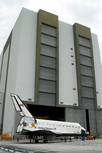 NASA image: KENNEDY SPACE CENTER, FLA. -- Endeavour is towed in front of the Vehicle Assembly Building (VAB) where it is going for temporary storage.  The orbiter has been moved from the Orbiter Processing Facility (OPF) to allow work to be performed in the OPF that can only be accomplished while the bay is empty. Work scheduled in the OPF includes annual validation of the bay’s cranes, work platforms, lifting mechanisms and jack stands. Endeavour will remain in the VAB for approximately 12 days, then return to the OPF.