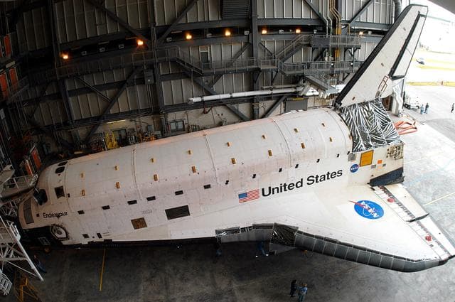 NASA image: KENNEDY SPACE CENTER, FLA. -- Endeavour settles into  place inside the Vehicle Assembly Building (VAB) where it has been moved for temporary storage.  It left the Orbiter Processing Facility (OPF) to allow work to be performed in the OPF that can only be accomplished while the bay is empty. Work scheduled in the OPF includes annual validation of the bay’s cranes, work platforms, lifting mechanisms and jack stands. Endeavour will remain in the VAB for approximately 12 days, then return to the OPF.