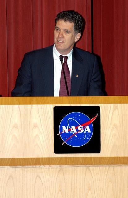 NASA image: KENNEDY SPACE CENTER, FLA. -- U.S. Rep. Dave Weldon addresses employees in a Town Hall meeting at KSC with comments on the new mission for NASA outlined by President George W. Bush Jan. 14.  He shared the stage with U.S. Rep. Tom Feeney and Center Director Jim Kennedy.  All three later answered questions from employees in the audience.
