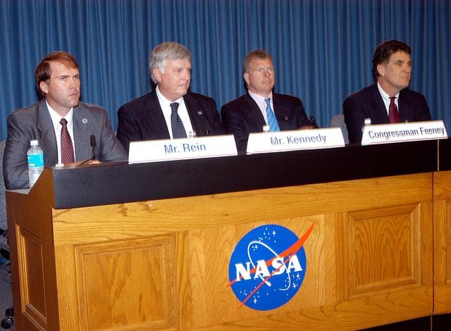 NASA image: KENNEDY SPACE CENTER, FLA. -- Mike Rein (at left), division chief of KSC External Affairs, moderates the press conference featuring (second from left to right) U.S. Rep. Tom Feeney, Center Director Jim Kennedy and U.S. Rep. Dave Weldon.  The media were interested in hearing Kennedy’s and the congressmen’s reactions to the new mission for NASA outlined by President George W. Bush Jan. 14.