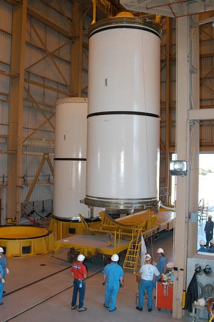 NASA image: KENNEDY SPACE CENTER, FLA. -  In the Rotation Processing and Surge Facility, an SRB solid segment is being moved to a rail car for shipment to Utah for testing.  The segment was part of the STS-114 stack.  It is the first time actual flight segments that had been stacked for flight in the VAB are being returned to Utah for testing.  It will undergo firing, which will enable inspectors to check the viability of the solid and verify the life expectancy for stacked segments.