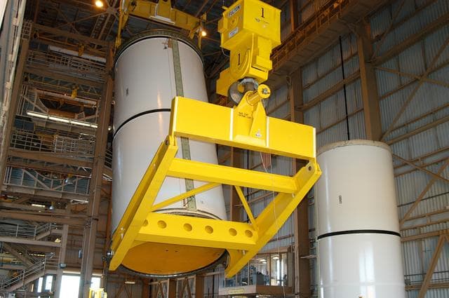 NASA image: KENNEDY SPACE CENTER, FLA. -  In the Rotation Processing and Surge Facility, an SRB solid segment is being lifted and moved to a rail car for shipment to Utah for testing.  The segment was part of the STS-114 stack.  It is the first time actual flight segments that had been stacked for flight in the VAB are being returned to Utah for testing.  It will undergo firing, which will enable inspectors to check the viability of the solid and verify the life expectancy for stacked segments.