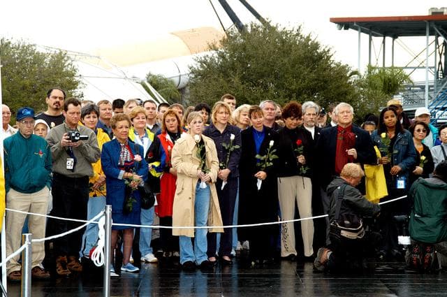 NASA image: KENNEDY SPACE CENTER, FLA. -  Friends, co-workers and families gather at the Space Memorial Mirror for KSC’s special service remembering and honoring the crew of Columbia.  Feb. 1 is the one-year anniversary of the loss of the crew and orbiter Columbia in a tragic accident as the ship returned to Earth following mission STS-107.  The public was invited to the memorial service held at the KSC Visitor Complex.  Participants included Center Director Jim Kennedy, Deputy Director Woodrow Whitlow Jr., Executive Director of Florida Space Authority Winston Scott, Dr. Stephen Feldman, president of the Astronaut Memorial Foundation, and dancers from the Shoshone-Bannock Native American community in Fort Hall, Idaho.