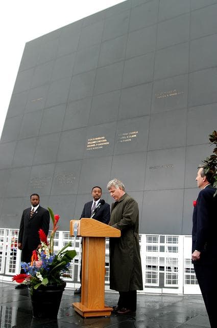 NASA image: KENNEDY SPACE CENTER, FLA. -  In front of the Space Memorial Mirror at the KSC Visitor Complex, Center Director Jim Kennedy (right) speaks to visitors gathered for the memorial service honoring the crew of Columbia.   At left are KSC Deputy Director Woodrow Whitlow Jr. and Executive Director of Florida Space Authority Winston Scott; at right is  Dr. Stephen Feldman, president of the Astronaut Memorial Foundation.  Feb. 1 is the one-year anniversary of the loss of the crew and orbiter Columbia in a tragic accident as the ship returned to Earth following mission STS-107.  The public was also invited to the memorial service held at the KSC Visitor Complex.