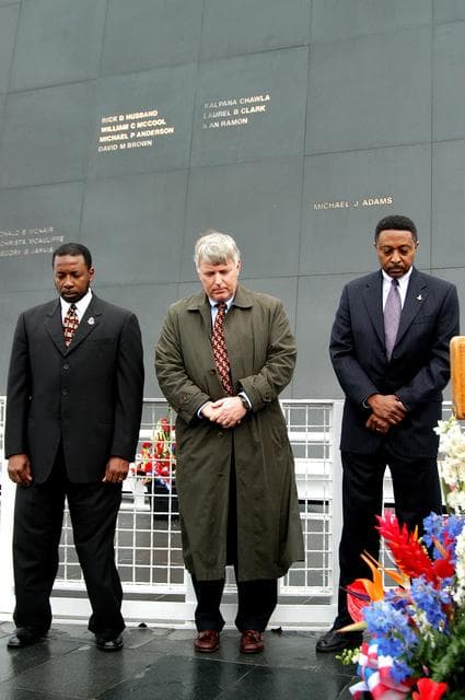 NASA image: KENNEDY SPACE CENTER, FLA. -  Standing in front of the Space Memorial Mirror at the KSC Visitor Complex, KSC Deputy Director Woodrow Whitlow Jr., Center Director Jim Kennedy and Executive Director of Florida Space Authority Winston Scott bow their heads in prayer during a memorial service remembering and honoring the crew of Columbia.  Feb. 1 is the one-year anniversary of the loss of the crew and orbiter Columbia in a tragic accident as the ship returned to Earth following mission STS-107.  Scott is a former astronaut who flew on Columbia in 1997. The public was also invited to the memorial service.