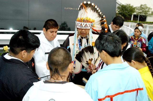 NASA image: KENNEDY SPACE CENTER, FLA. - Dancers from the Shoshone-Bannock Junior-Senior High School, Fort Hall, Idaho, perform a healing ceremony during the memorial service held at the Space Memorial Mirror for the crew of Columbia.  Feb. 1 is the one-year anniversary of the loss of the crew and orbiter Columbia in a tragic accident as the ship returned to Earth following mission STS-107.  Students and staff of the Shoshone-Bannock Nation had an experiment on board Columbia. The public was invited to the memorial service, held in the KSC Visitor Complex, which included comments by Center Director Jim Kennedy and Executive Director of Florida Space Authority Winston Scott.  Scott is a former astronaut who flew on Columbia in 1997.