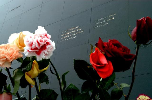 NASA image: KENNEDY SPACE CENTER, FLA. - Brilliant roses and carnations frame the names of the Columbia crew carved onto the black granite surface of the Astronaut Memorial Mirror at the KSC Visitor Complex.  The flowers were left by visitors who attended a memorial service for the crew on the anniversary of the tragic accident that claimed their lives Feb. 1, 2003.  The service included comments by Center Director Jim Kennedy, Deputy Director Woodrow Whitlow Jr., Executive Director of Florida Space Authority Winston Scott, and Dr. Stephen Feldman, president of the Astronaut Memorial Foundation, who placed the wreath at the mirror.  The mirror honors astronauts who have given their lives for space exploration.