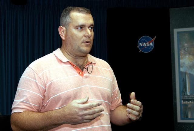 NASA image: KENNEDY SPACE CENTER, FLA. - Armando Oliu, Final Inspection Team lead for the Shuttle program, speaks to reporters about the aid the Image Analysis Lab is giving the FBI in a kidnapping case.  Oliu oversees the image lab that is using an advanced SGI® TP9500 data management system to review the tape of the kidnapping in progress in Sarasota, Fla.  KSC installed the new $3.2 million system in preparation for Return to Flight of the Space Shuttle fleet.  The lab is studying the Sarasota kidnapping video to provide any new information possible to law enforcement officers.  KSC is joining NASA’s Marshall Space Flight Center in Alabama in reviewing the tape.