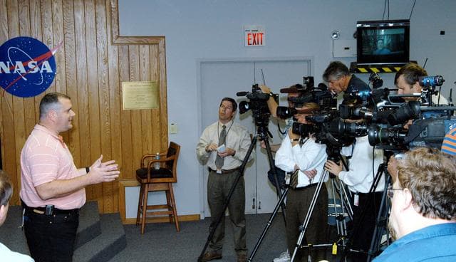 NASA image: KENNEDY SPACE CENTER, FLA. - Armando Oliu, Final Inspection Team lead for the Shuttle program, speaks to reporters about the aid the Image Analysis Lab is giving the FBI in a kidnapping case.  Oliu oversees the image lab that is using an advanced SGI® TP9500 data management system to review the tape of the kidnapping in progress in Sarasota, Fla.  KSC installed the new $3.2 million system in preparation for Return to Flight of the Space Shuttle fleet.  The lab is studying the Sarasota kidnapping video to provide any new information possible to law enforcement officers.  KSC is joining NASA’s Marshall Space Flight Center in Alabama in reviewing the tape.