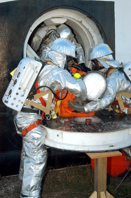 NASA image: KENNEDY SPACE CENTER, FLA. - Emergency crew members “rescue” an injured astronaut from the orbiter crew compartment mock-up during a “Mode VII” emergency landing simulation at Kennedy Space Center.  The purpose of the Mode VII is to exercise emergency preparedness personnel, equipment and facilities in rescuing astronauts from a downed orbiter and providing immediate medical attention.  This simulation presents an orbiter that has crashed short of the Shuttle Landing Facility in a wooded area 2-1/2 miles south of Runway 33.  Emergency crews are responding to the volunteer astronauts who are simulating various injuries.  Rescuers must remove the crew, provide triage and transport to hospitals those who need further treatment.  Local hospitals are participating in the exercise.