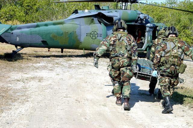NASA image: KENNEDY SPACE CENTER, FLA. - A rescue team carries an “injured” astronaut toward the helicopter for transportation to a local hospital.  They are all taking part in a “Mode VII” emergency landing simulation at Kennedy Space Center.  The purpose of the Mode VII is to exercise emergency preparedness personnel, equipment and facilities in rescuing astronauts from a downed orbiter and providing immediate medical attention.  This simulation presents an orbiter that has crashed short of the Shuttle Landing Facility in a wooded area 2-1/2 miles south of Runway 33.  Emergency crews are responding to the volunteer astronauts who are simulating various injuries inside the crew compartment mock-up.  Rescuers must remove the crew, provide triage and transport to hospitals those who need further treatment.  Local hospitals are participating in the exercise. Emergency crews are responding to the volunteer astronauts who are simulating various injuries inside the crew compartment mock-up.  Rescuers must remove the crew, provide triage and transport to hospitals those who need further treatment.  Local hospitals are participating in the exercise.
