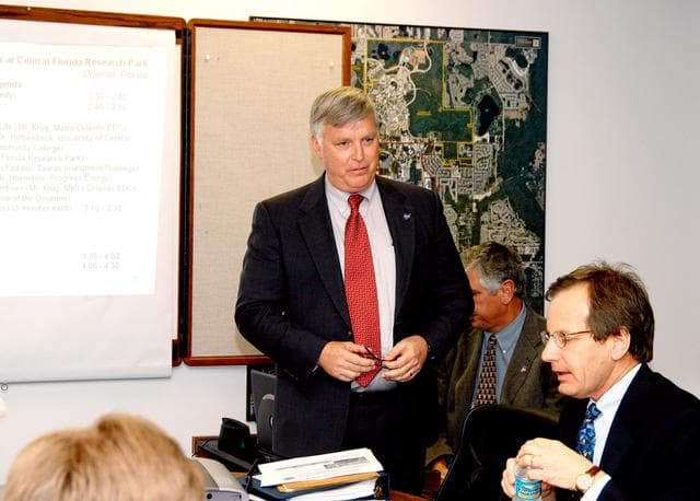NASA image: KENNEDY SPACE CENTER, FLA. - KSC Director Jim Kennedy (center) makes a presentation to NASA and other officials about the benefits of locating NASA’s new Shared Services Center in the Central Florida Research Park, near Orlando.  Central Florida leaders are proposing the research park as the site for the NASA Shared Services Center.  The center would centralize NASA’s payroll, accounting, human resources, facilities and procurement offices that are now handled at each field center.  The consolidation is part of the One NASA focus.  Six sites around the U.S. are under consideration by NASA.