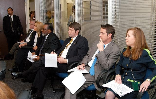 NASA image: KENNEDY SPACE CENTER, FLA. - NASA and government officials are gathered to hear about the assets of the Central Florida Research Park, near Orlando, as the site of NASA’s new Shared Services Center.  Seated at right are Lisa Malone, director of KSC External Affairs, and Joel Wells, with the Government Relations Office.  Fourth from right is Jim Jennings, NASA deputy associate administrator for institutions and asset management. Six sites around the U.S. are under consideration for the center, which would centralize NASA’s payroll, accounting, human resources, facilities and procurement offices that are now handled at each field center.  The consolidation is part of the One NASA focus.