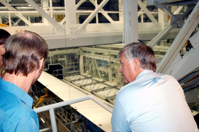 NASA image: KENNEDY SPACE CENTER, FLA. - On a tour of the Orbiter Processing Facility, Center Director Jim Kennedy (right) looks over some of the work being done on the orbiter Endeavour.  At left is Tom Roberts, who is with United Space Alliance.  Endeavour is in its Orbiter Major Modification period, which began in December 2003.