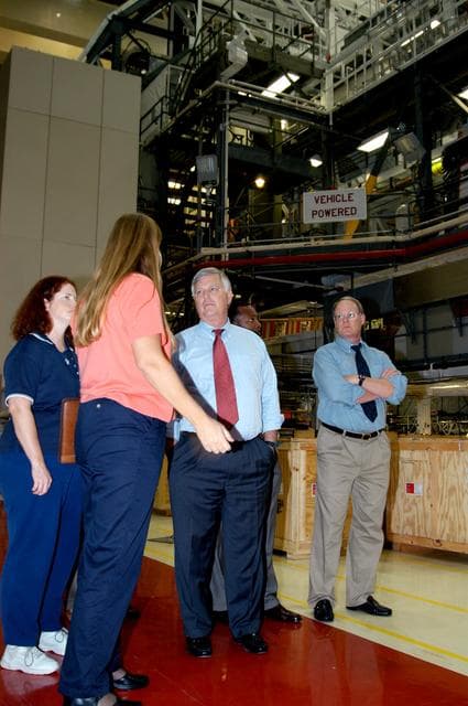 NASA image: KENNEDY SPACE CENTER, FLA. - Standing near Endeavour in the Orbiter Processing Facility are (left to right) Joy Huff, with KSC Space Shuttle Processing; Kathy Laufenberg, with United Space Alliance; Center Director Jim Kennedy; and Bruce Buckingham, assistant to Deputy Director Woodrow Whitlow Jr.  Kennedy and Whitlow are touring the OPF, viewing the work being done on Endeavour, which is in its Orbiter Major Modification period.