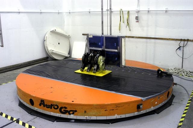 NASA image: KENNEDY SPACE CENTER, FLA. -  A rudder speed brake actuator sits on an air-bearing pallet to undergo X-raying.  Four actuators to be installed on the orbiter Discovery are being X-rayed at the Radiographic High-Energy X-ray Facility to determine if the gears were installed correctly. Discovery has been assigned to the first Return to Flight mission, STS-114, a logistics flight to the International Space Station.