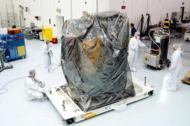 NASA image: KENNEDY SPACE CENTER, FLA. -  In the high bay clean room at the Astrotech Space Operations processing facilities near KSC, workers get ready to remove the protective cover from NASA’s MESSENGER spacecraft.  Employees of the Johns Hopkins University Applied Physics Laboratory, builders of the spacecraft, will perform an initial state-of-health check.  Then processing for launch can begin, including checkout of the power systems, communications systems and control systems.  The thermal blankets will also be attached for flight.  MESSENGER - short for MErcury Surface, Space ENvironment, GEochemistry and Ranging - will be launched May 11 on a six-year mission aboard a Boeing Delta II rocket.  Liftoff is targeted for 2:26 a.m. EDT on Tuesday, May 11.