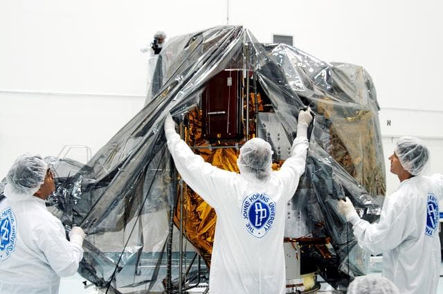 NASA image: KENNEDY SPACE CENTER, FLA. -  In the high bay clean room at the Astrotech Space Operations processing facilities near KSC, workers remove the protective cover from NASA’s MESSENGER spacecraft.  Employees of the Johns Hopkins University Applied Physics Laboratory, builders of the spacecraft, will perform an initial state-of-health check.  Then processing for launch can begin, including checkout of the power systems, communications systems and control systems.  The thermal blankets will also be attached for flight.  MESSENGER - short for MErcury Surface, Space ENvironment, GEochemistry and Ranging - will be launched May 11 on a six-year mission aboard a Boeing Delta II rocket.  Liftoff is targeted for 2:26 a.m. EDT on Tuesday, May 11.