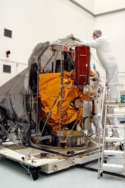 NASA image: KENNEDY SPACE CENTER, FLA. -  In the high bay clean room at the Astrotech Space Operations processing facilities near KSC, workers remove the protective cover from NASA’s MESSENGER spacecraft.  Employees of the Johns Hopkins University Applied Physics Laboratory, builders of the spacecraft, will perform an initial state-of-health check.  Then processing for launch can begin, including checkout of the power systems, communications systems and control systems.  The thermal blankets will also be attached for flight.  MESSENGER - short for MErcury Surface, Space ENvironment, GEochemistry and Ranging - will be launched May 11 on a six-year mission aboard a Boeing Delta II rocket.  Liftoff is targeted for 2:26 a.m. EDT on Tuesday, May 11.