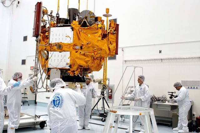 NASA image: KENNEDY SPACE CENTER, FLA. -  At the Astrotech Space Operations processing facilities, an overhead crane lowers NASA’s MESSENGER spacecraft onto a work stand. There employees of the Johns Hopkins University Applied Physics Laboratory, builders of the spacecraft, will perform an initial state-of-health check.  Then processing for launch can begin, including checkout of the power systems, communications systems and control systems.  The thermal blankets will also be attached for flight.  MESSENGER - short for MErcury Surface, Space ENvironment, GEochemistry and Ranging - will be launched May 11 on a six-year mission aboard a Boeing Delta II rocket.  Liftoff is targeted for 2:26 a.m. EDT on Tuesday, May 11.