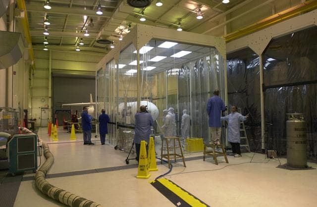 Technicians prepare the AIM spacecraft for fairing installation