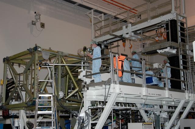 NASA image: Workers prepare to connect cables that will recharge the battery