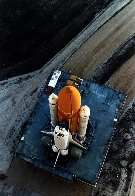 NASA image: KENNEDY SPACE CENTER, FLA. -  The Space Shuttle Discovery on its Mobile Launcher Platform slowly moves through the high bay doors of the Vehicle Assembly Building en route to Launch Pad 39A, where Discovery is scheduled to lift off on the STS-82 mission on Feb. 11.  A seven-member crew will perform the second servicing of the orbiting Hubble Space Telescope (HST) during the 10-day STS-82 mission.
