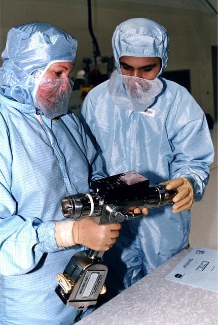 KENNEDY SPACE CENTER, FLA. -  In KSC's Vertical Processing Facility, Louise Kleba of the Vehicle Integration Test Team (VITT) and engineer Devin Tailor of Goddard Space Flight Center examine the Pistol Grip Tool (PGT), which was designed for use by astronauts during spacewalks.  The PGT is a self-contained, micro-processor controlled, battery-powered tool.  It also can be used as a nonpowered ratchet wrench.  The experiences of the astronauts on the first Hubble Space Telescope (HST) servicing mission led to recommendations for this smaller, more efficient tool for precision work during spacewalks.  The PGT will be used on the second HST servicing mission, STS-82.  Liftoff aboard Discovery is scheduled Feb. 11.
