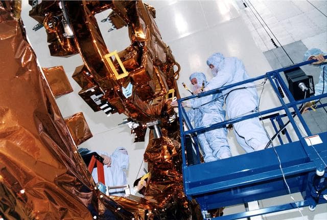 NASA image: KENNEDY SPACE CENTER, FLA. -  STS-82 crew members examine part of the Flight Support System during the Crew Equipment Integration Test (CEIT) in KSC's Vertical Processing Facility.  From left are Mission Specialists Steven L. Smith and Gregory J. Harbaugh and Payload Commander Mark C. Lee.  Liftoff of STS-82, the second Hubble Space Telescope (HST) servicing mission, is scheduled Feb. 11 aboard Discovery with a crew of seven.