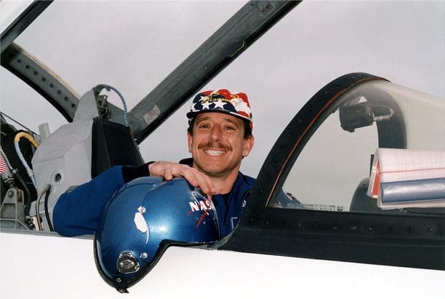 NASA image: KENNEDY SPACE CENTER, FLA. -  STS-82 Pilot Scott J. "Doc" Horowitz flashes a wide grin for photographers after landing his T-38 jet at KSC's Shuttle Landing Facility.  Horowitz and the other six members of the STS-82 crew came from their home base at Johnson Space Center in Houston, Texas, to spend the last few days before launch at KSC.   STS-82 is scheduled for liftoff on Feb. 11 during a 65-minute launch window that opens at 3:56 a.m. EST.  The 10-day flight aboard the Space Shuttle Discovery will be the second Hubble Space Telescope (HST) servicing mission.