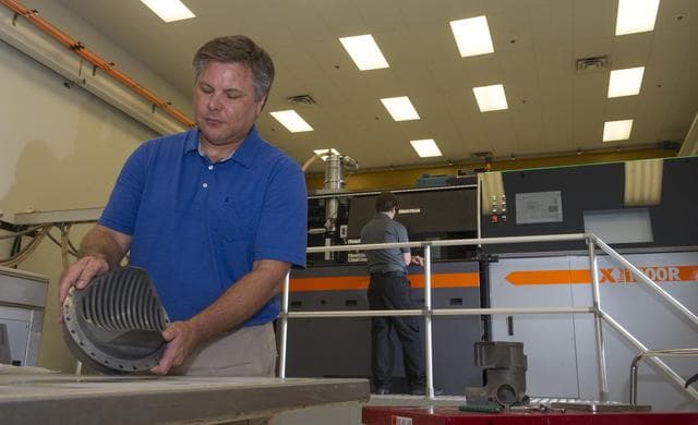 NASA image: Andy Hardin with 3-D printed engine part
