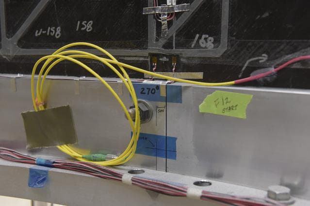 NASA image: INSTALLATION OF STRESS SENSORS TO SBKF COMPOSITE TANK