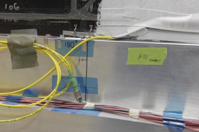 NASA image: INSTALLATION OF STRESS SENSORS TO SBKF COMPOSITE TANK