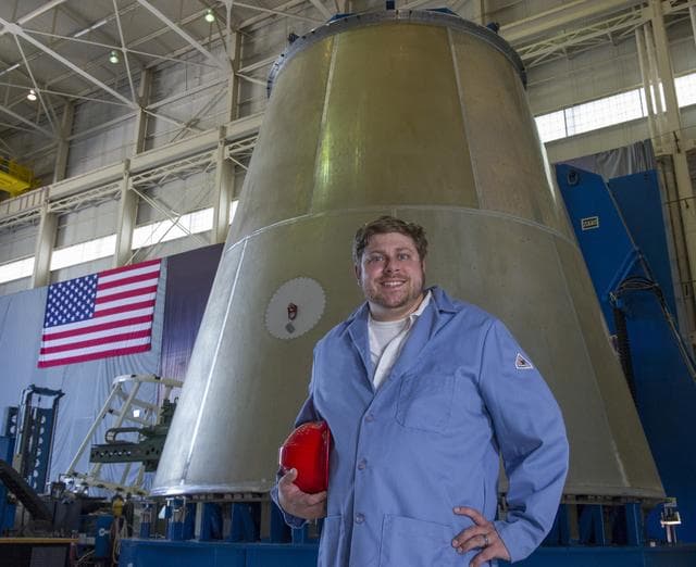 NASA image: MARSHALL WELD ENGINEER JUSTIN LITTELL POSES WITH LAUNCH VEHICLE 