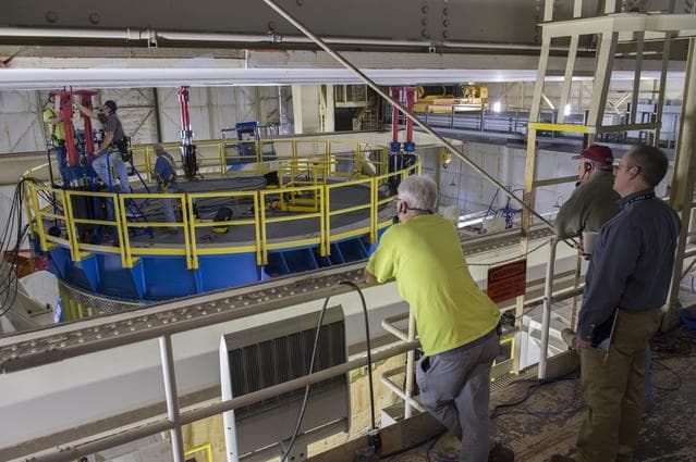NASA image: SLS Intertank Test Article, ITA, is attached to crosshead of load testAnnex, Bldg. 4619, and removed from bed of KMAG transporter