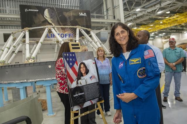 NASA image: Astronaut Suni Williams poses with a poster of herself as she tours ULA facility in Decatur, Al