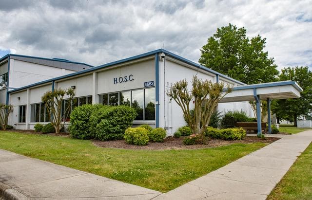 NASA image:  MSFC Building 4663, NW corner view showing entrance to Huntsville Operations Support Center (HOSC).