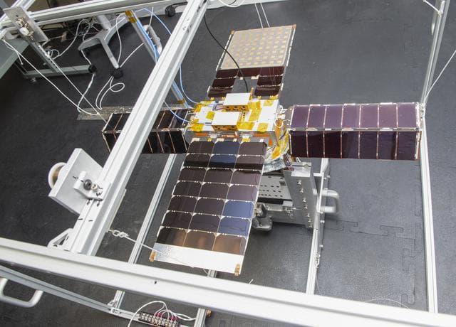 NASA image: Spacecraft in Gravity Off-load Fixture (GOLF), System Test configuration - Arisa Waddle – Test Engineer,  Rick Wilson – Lead Test Engineer