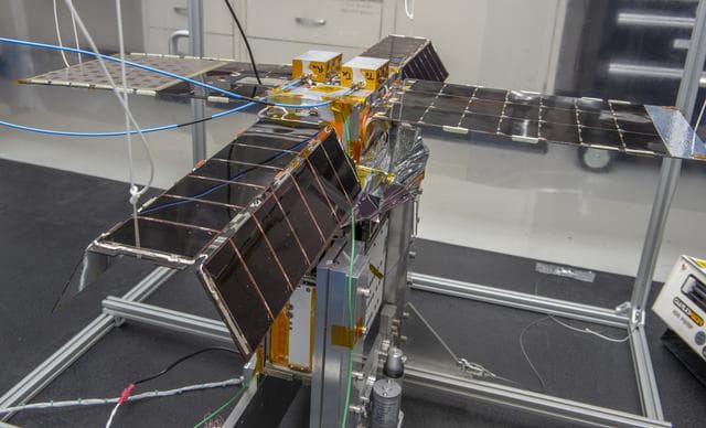 NASA image: Spacecraft in Gravity Off-load Fixture (GOLF), System Test configuration - Arisa Waddle – Test Engineer,  Rick Wilson – Lead Test Engineer