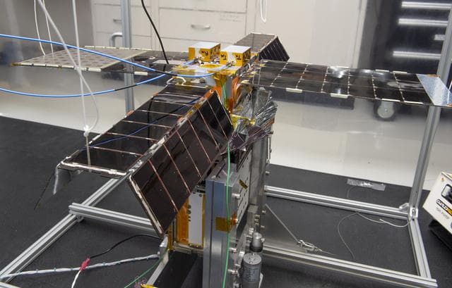 NASA image: Spacecraft in Gravity Off-load Fixture (GOLF), System Test configuration - Arisa Waddle – Test Engineer,  Rick Wilson – Lead Test Engineer