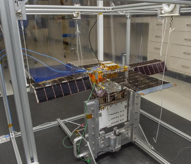 NASA image: Spacecraft in Gravity Off-load Fixture (GOLF), System Test configuration - Arisa Waddle – Test Engineer,  Rick Wilson – Lead Test Engineer