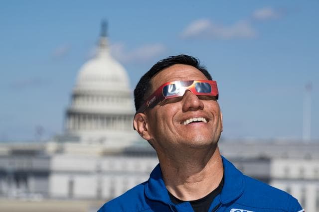 NASA image: Expedition 69 Crew Wears Solar Eclipse Glasses