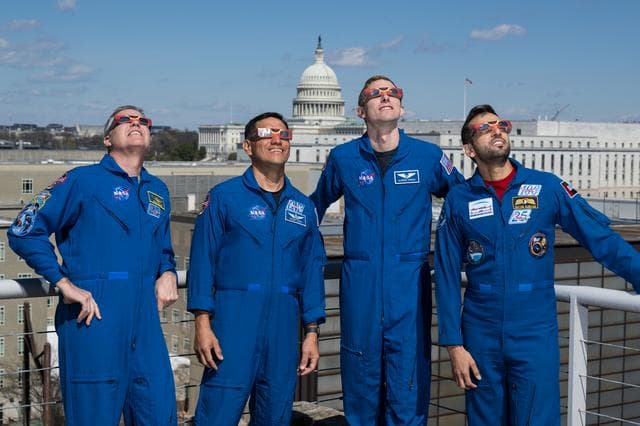 NASA image: Expedition 69 Crew Wears Solar Eclipse Glasses