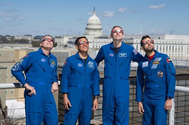 NASA image: Expedition 69 Crew Wears Solar Eclipse Glasses
