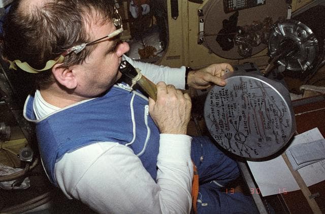NASA image: Strekalov writes procedures on lid of can